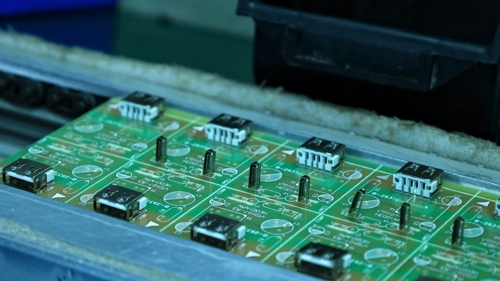 Circuit boards moving along a production conveyor